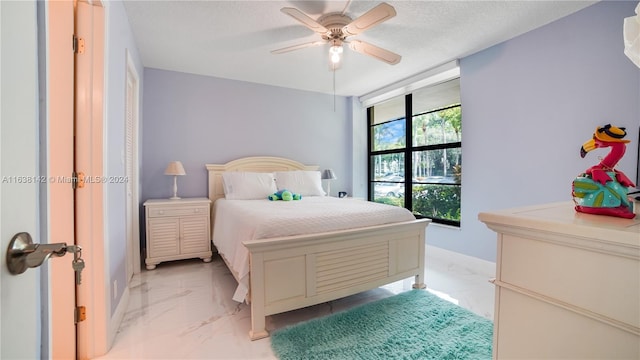 bedroom featuring light tile patterned flooring, a textured ceiling, and ceiling fan