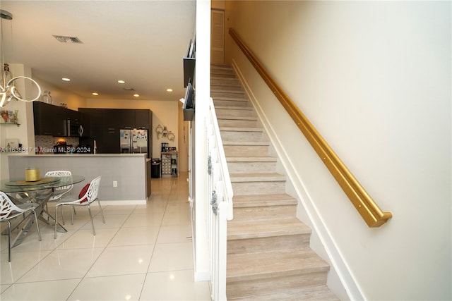 staircase featuring tile patterned flooring