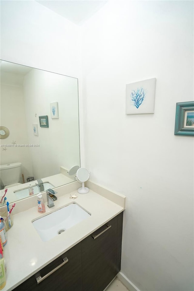 bathroom with vanity and toilet