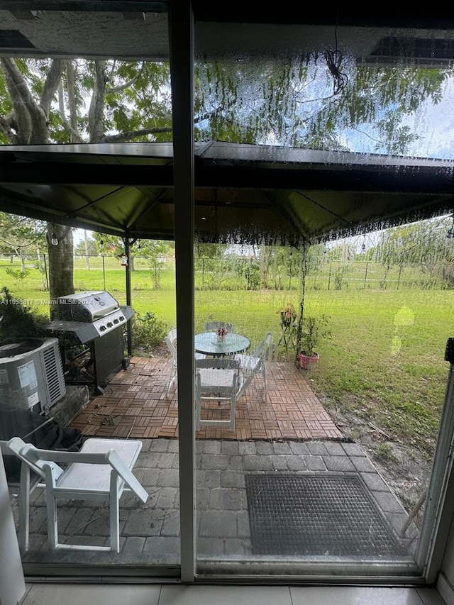 exterior space featuring a water view, central AC, and a grill