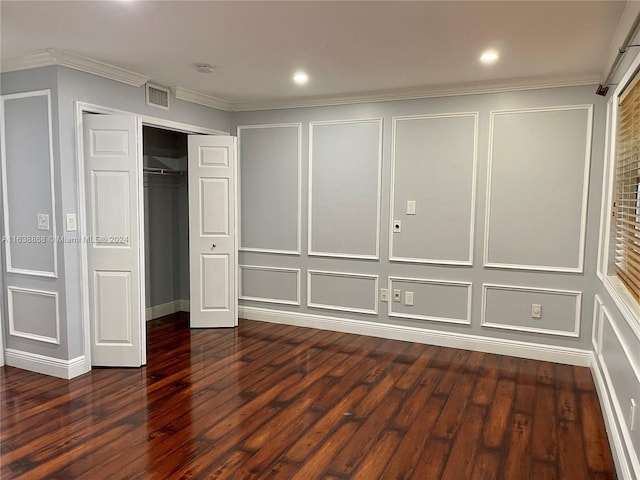 unfurnished bedroom with crown molding, wood-type flooring, and a closet