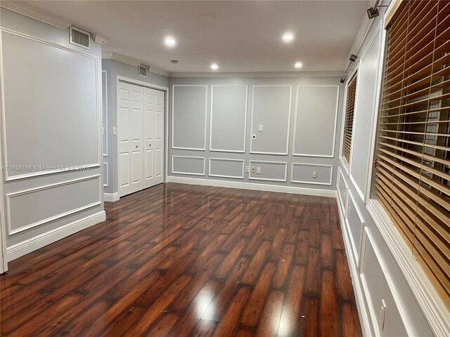 interior space featuring dark wood-type flooring and crown molding