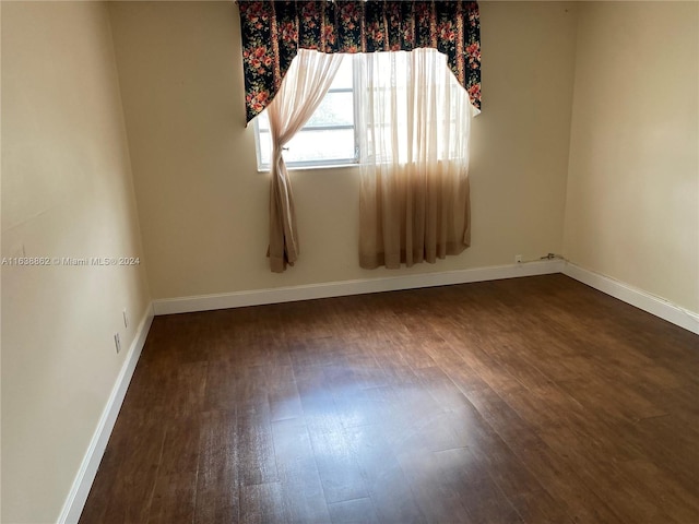 empty room featuring dark wood-type flooring