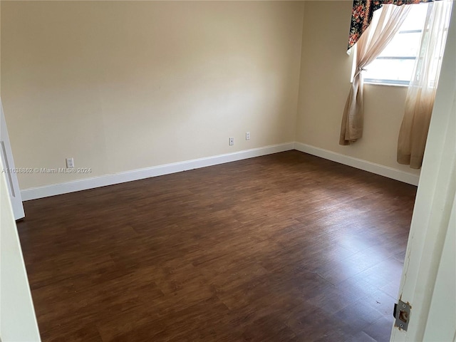 empty room featuring dark hardwood / wood-style flooring