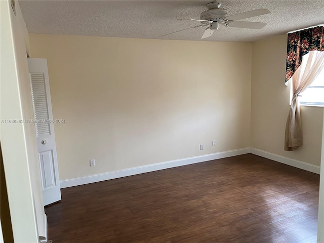 empty room with a textured ceiling, ceiling fan, and dark wood-type flooring