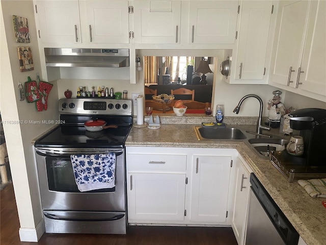 kitchen featuring sink, light stone countertops, range hood, appliances with stainless steel finishes, and white cabinetry