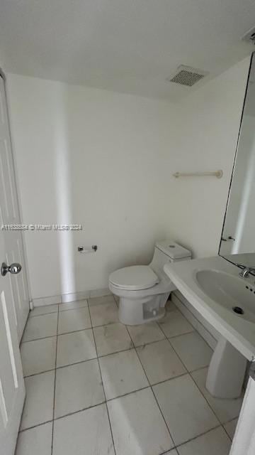 bathroom with tile patterned floors and toilet