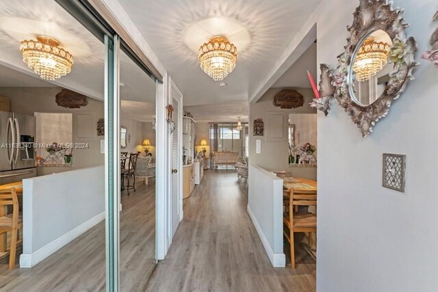 hall with a chandelier and hardwood / wood-style flooring