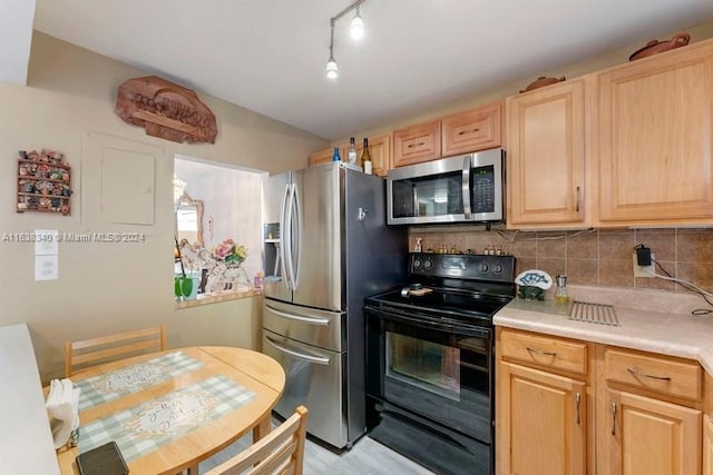 kitchen with appliances with stainless steel finishes, decorative backsplash, light countertops, and light brown cabinetry