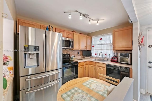 kitchen featuring black appliances, light brown cabinets, light countertops, and a sink