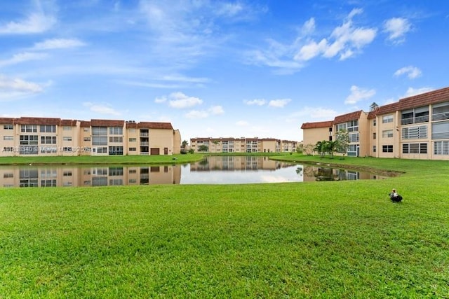 exterior space featuring a yard and a water view