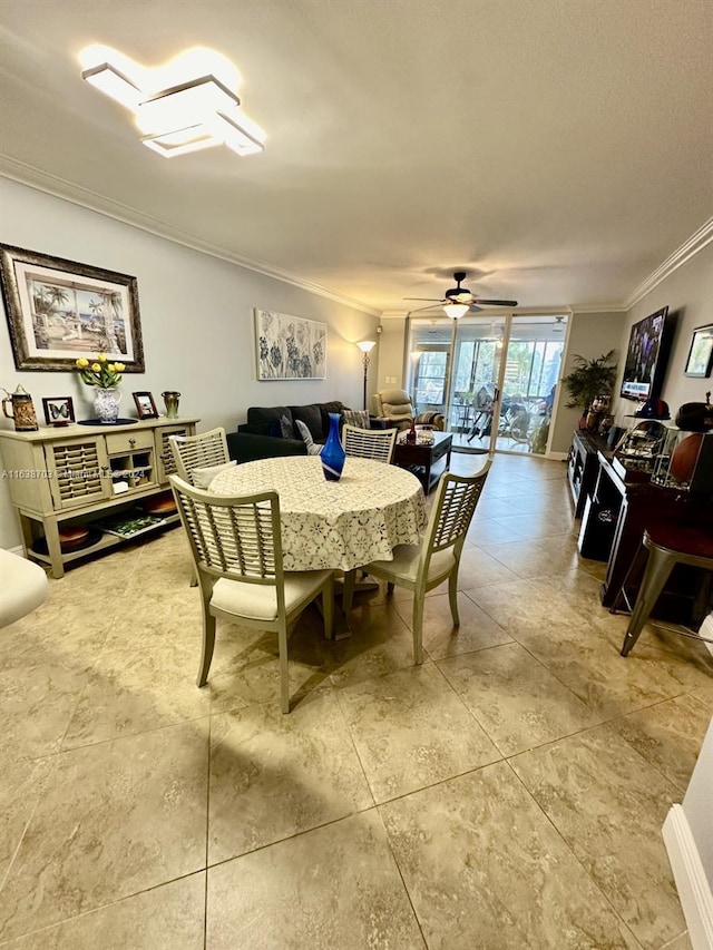 dining space featuring ceiling fan and ornamental molding