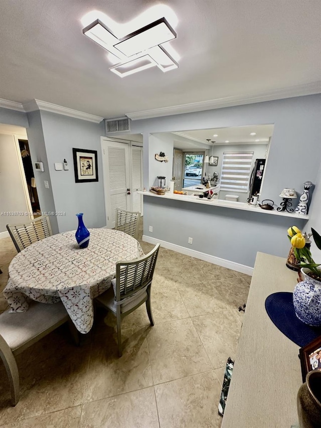 dining room featuring light tile patterned floors and ornamental molding