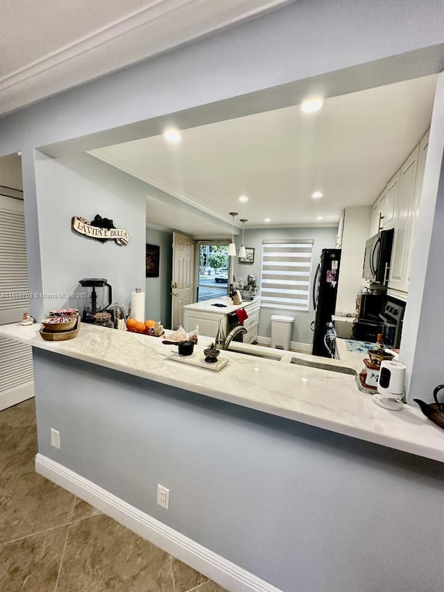 kitchen with black appliances, white cabinets, dark tile patterned flooring, sink, and kitchen peninsula