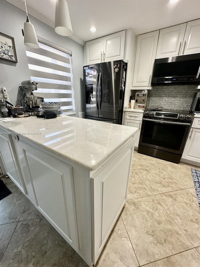 kitchen featuring hanging light fixtures, tasteful backsplash, light stone counters, white cabinetry, and stainless steel appliances