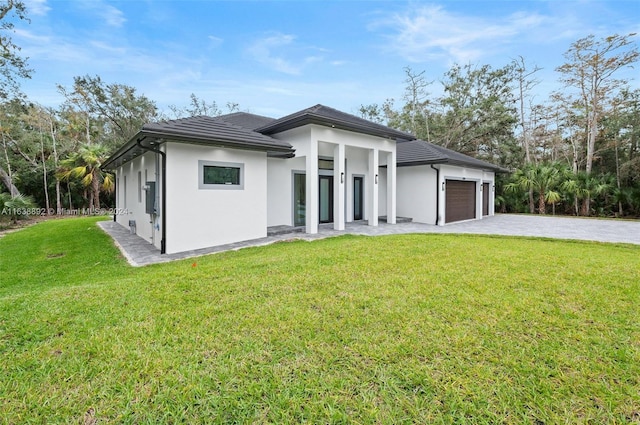 exterior space with a yard and a garage