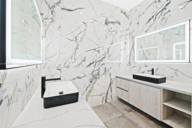 bathroom with tile patterned floors, vanity, and tile walls