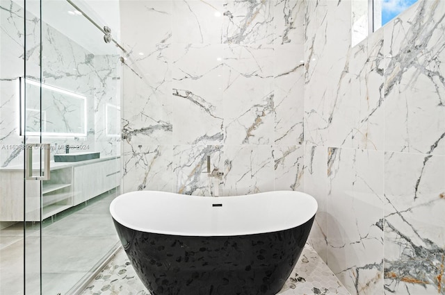 bathroom with tile walls, tile patterned floors, and independent shower and bath