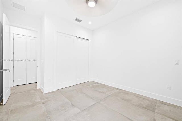 tiled empty room with ceiling fan