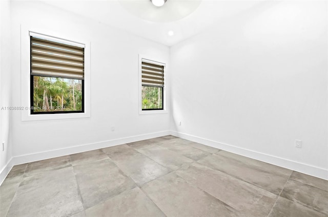 unfurnished room featuring light tile patterned flooring and a healthy amount of sunlight