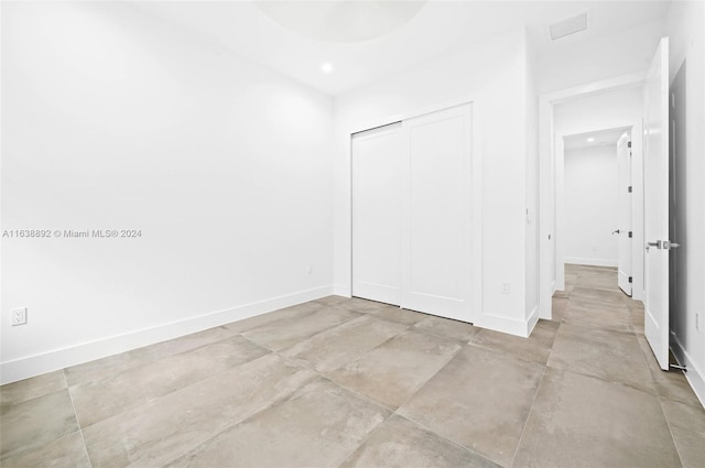 unfurnished bedroom with a closet and light tile patterned floors