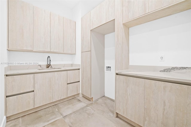 kitchen with light tile patterned flooring, sink, and light brown cabinets