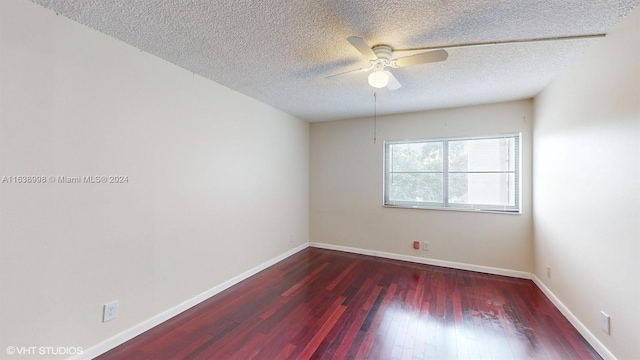 empty room featuring dark hardwood / wood-style floors, a textured ceiling, and ceiling fan