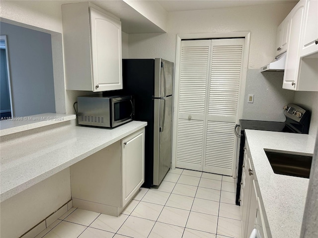 kitchen with sink, white cabinetry, stainless steel appliances, light tile patterned floors, and ventilation hood