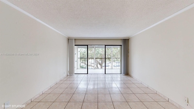 tiled empty room with crown molding and a textured ceiling