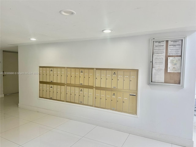 interior space with a mail area and light tile patterned flooring