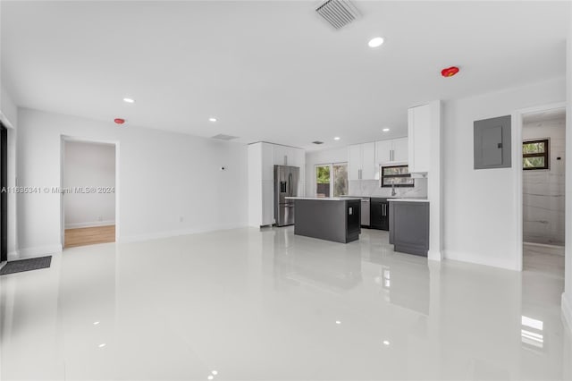 living room featuring light tile patterned floors and electric panel