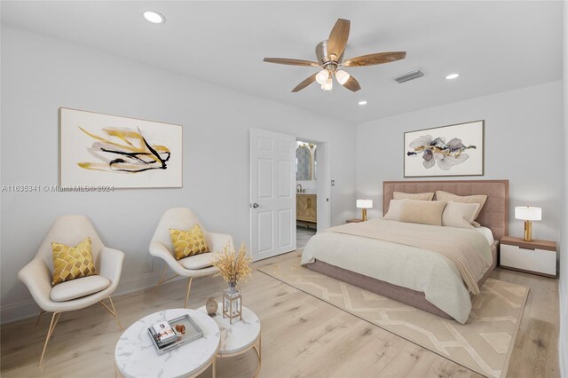 bedroom with light wood-type flooring, ensuite bath, and ceiling fan