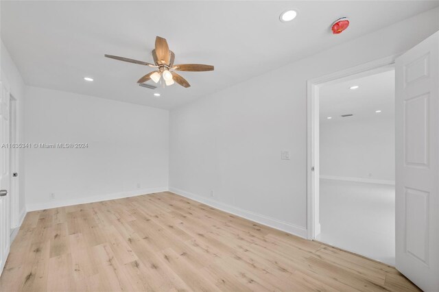 spare room featuring light hardwood / wood-style flooring and ceiling fan