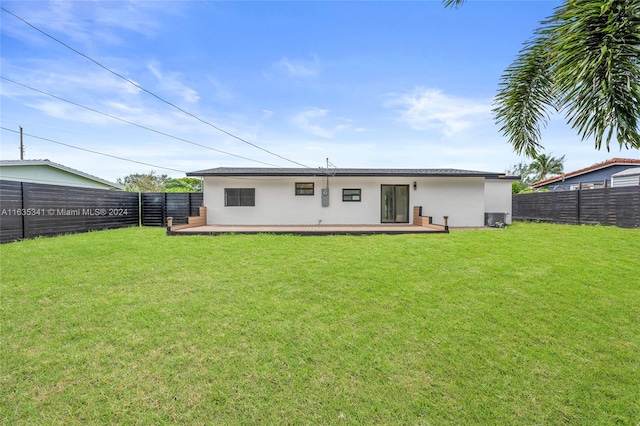 rear view of property featuring a yard