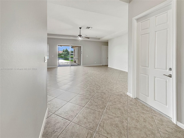 tiled spare room with ceiling fan