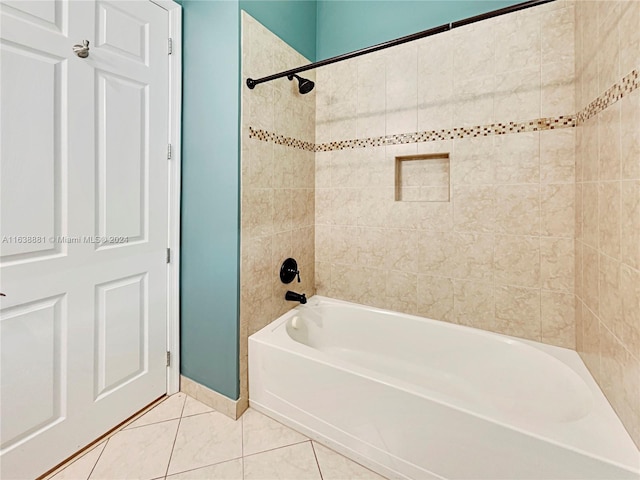 bathroom featuring tiled shower / bath combo and tile patterned flooring