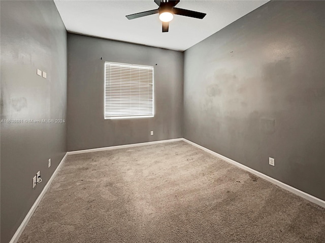 carpeted empty room featuring ceiling fan