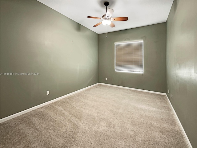 carpeted empty room with ceiling fan