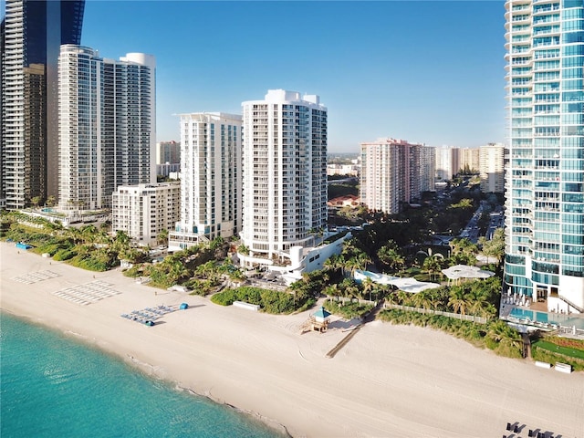 exterior space with a water view and a beach view