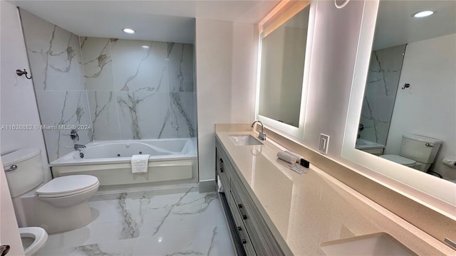 bathroom featuring vanity, a bathtub, and toilet