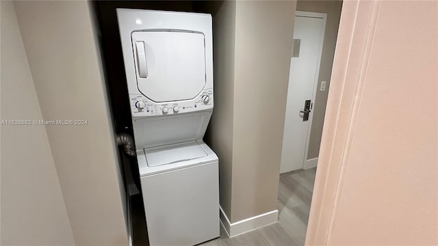 washroom with stacked washer and dryer