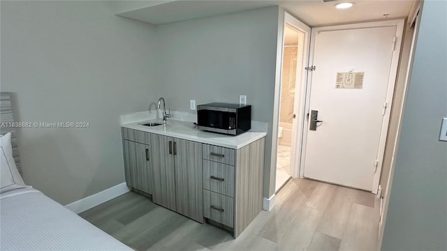 bathroom with wood-type flooring and sink