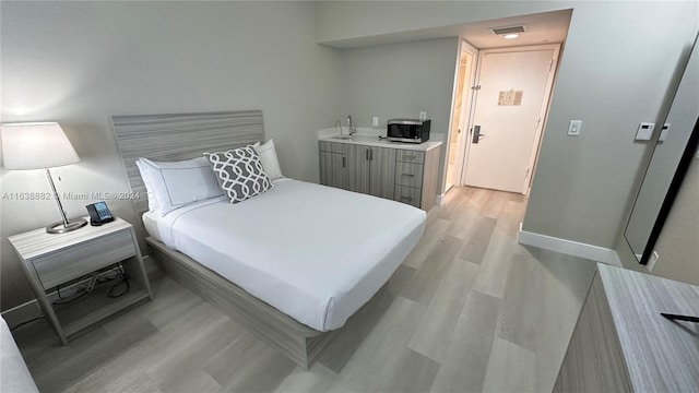 bedroom with light wood-type flooring