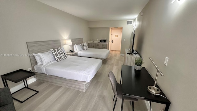 bedroom with light wood-type flooring