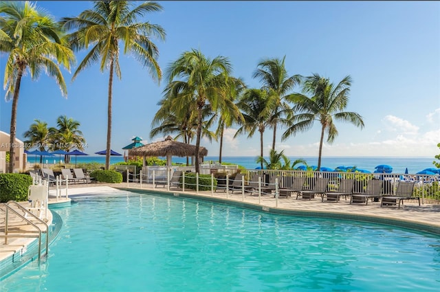 view of swimming pool with a water view, a patio area, and a gazebo