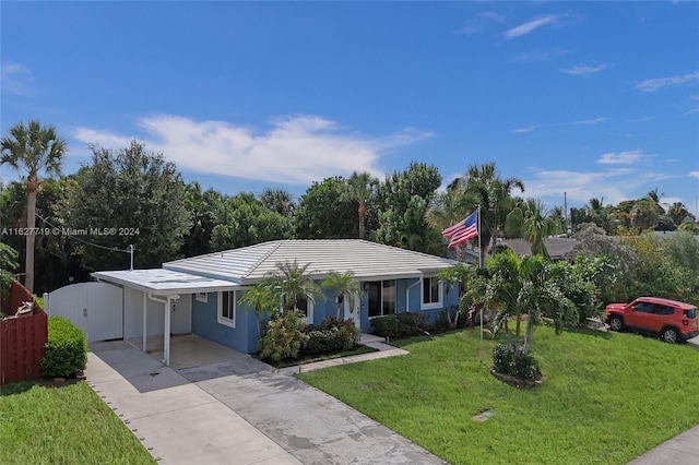 ranch-style house with a carport and a front lawn