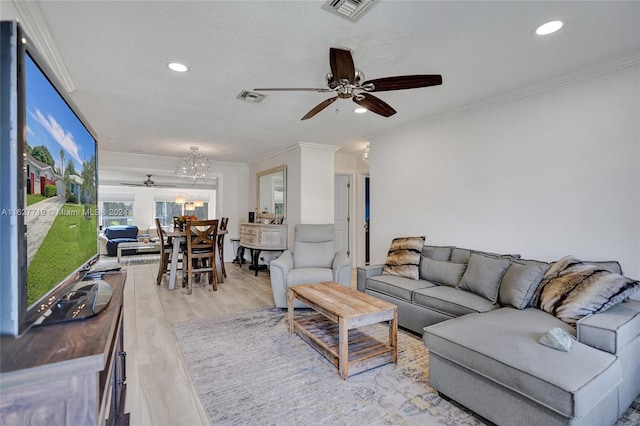 living room with ornamental molding, a textured ceiling, ceiling fan with notable chandelier, and light hardwood / wood-style floors