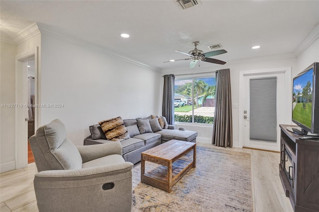 living room featuring ceiling fan, light wood-type flooring, and ornamental molding