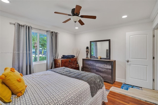 bedroom featuring ceiling fan, light wood-type flooring, and crown molding