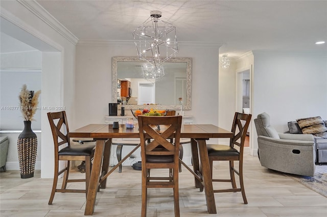 dining area featuring crown molding and a chandelier